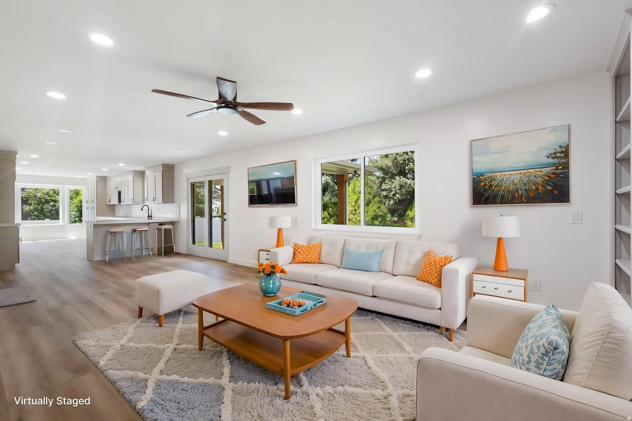 Open-concept living area featuring wood-finish flooring, recessed lighting, and a ceiling fan