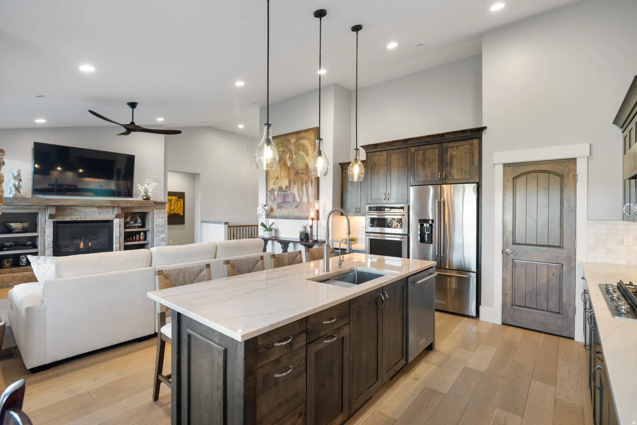 Kitchen island with a light-toned countertop and dark wood-finish cabinetry