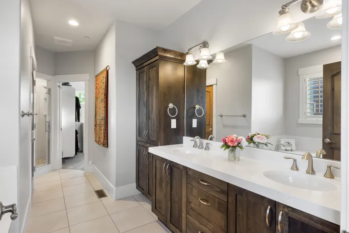 Dual vanity with white countertops, undermount sinks, and brushed nickel fixtures