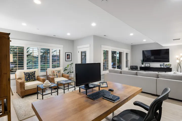 Open-concept living space with light wood-finish flooring