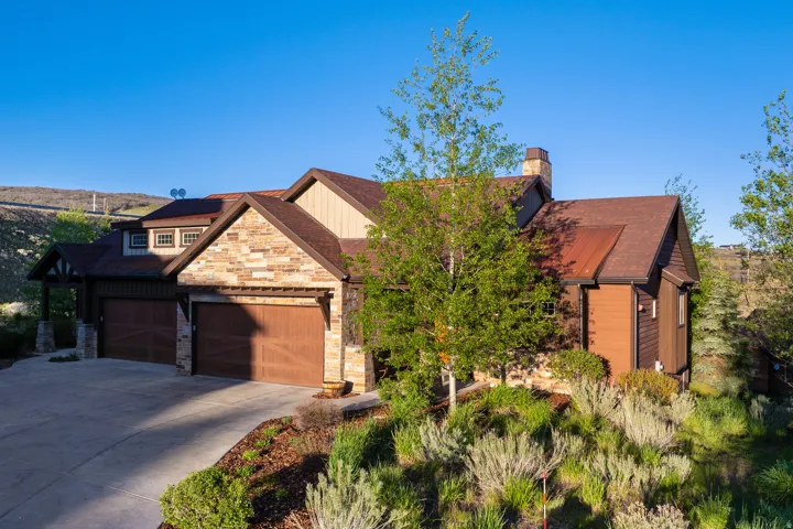 Stone and siding exterior with a multi-gabled roofline