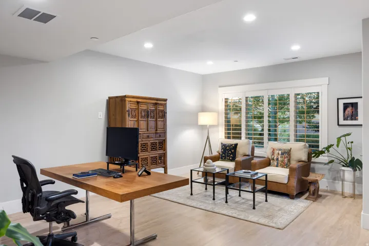 Light-colored wood-finish flooring complements the neutral wall tones