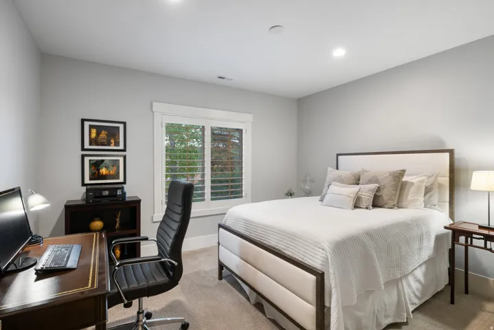 Carpeted room featuring a window with white plantation shutters, recessed lighting, and a neutral wall color