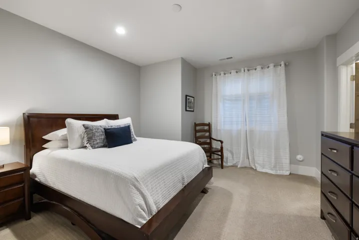 Wall-to-wall carpeting and neutral wall tones create a serene atmosphere