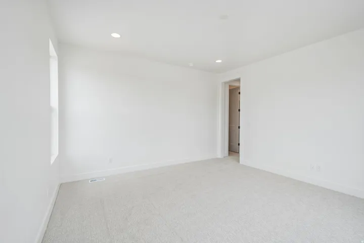 Carpeted room featuring a white interior, recessed lighting, and a single window