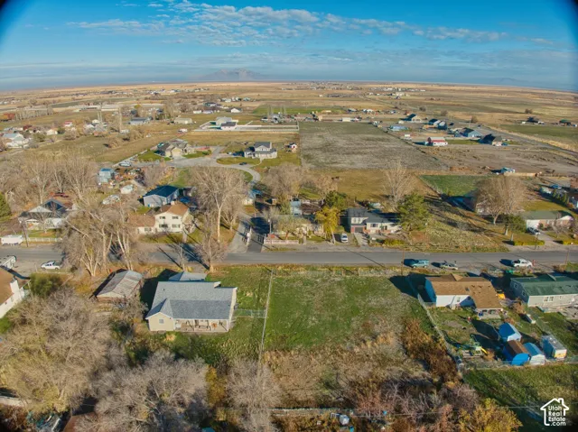 Aerial perspective showcasing a residential property with a gray shingle roof and a front porch