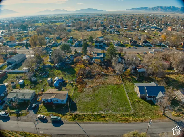 Expansive undeveloped lot featuring a grassed surface and perimeter fencing
