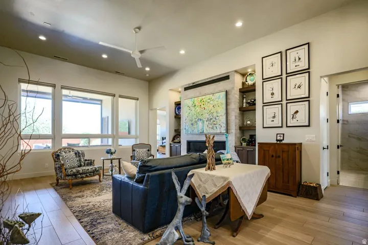 Bright living area featuring wood-finish flooring, recessed lighting, and a ceiling fan