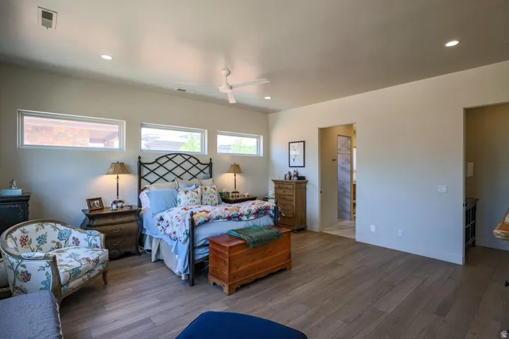 Vaulted ceilings with recessed lighting, ceiling fan, wood-finish flooring, and horizontal transom windows