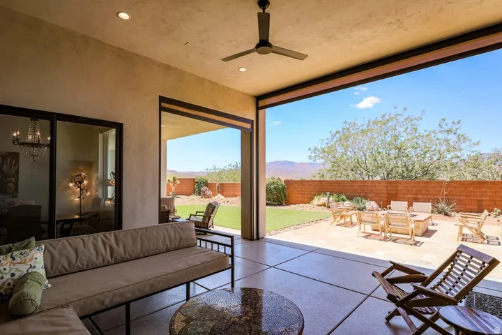 Expansive covered patio with concrete flooring, recessed lighting, and a ceiling fan