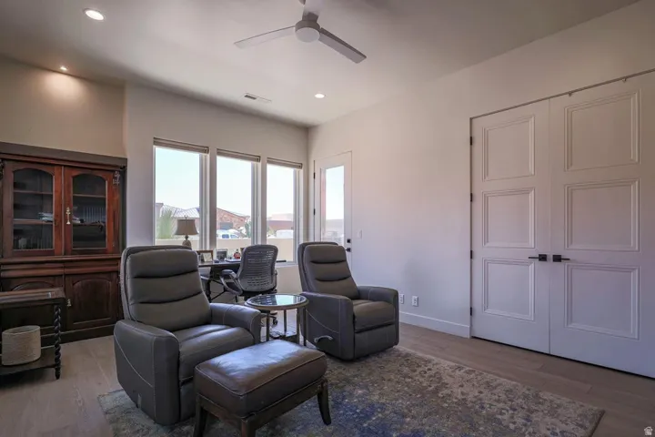 Recessed lighting, wood-finish flooring, ceiling fan, multiple windows, and paneled double doors