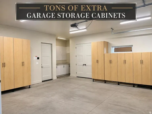 Concrete flooring, extensive built-in cabinetry, dual ceiling-mounted light fixtures, and a transom window