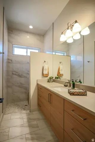 Floating wood-finish vanity with an integrated sink and light-toned countertop