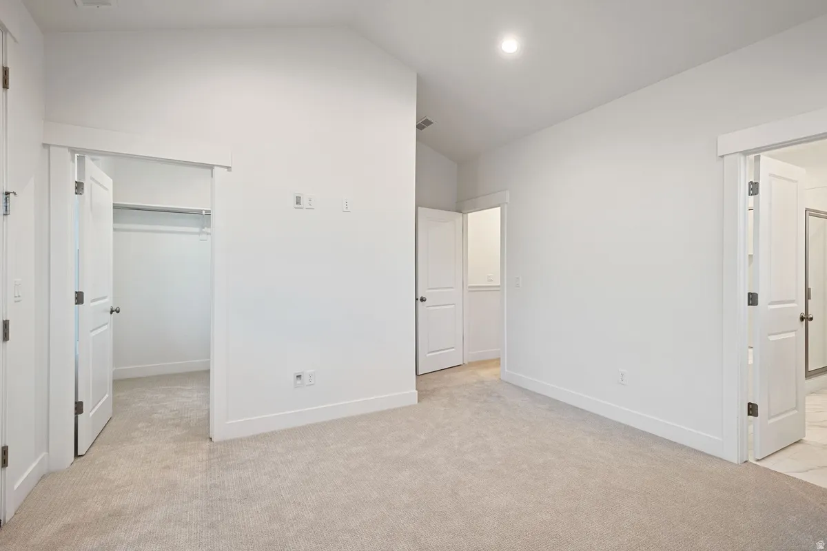 Carpeted room featuring white walls, white trim, and a recessed ceiling light