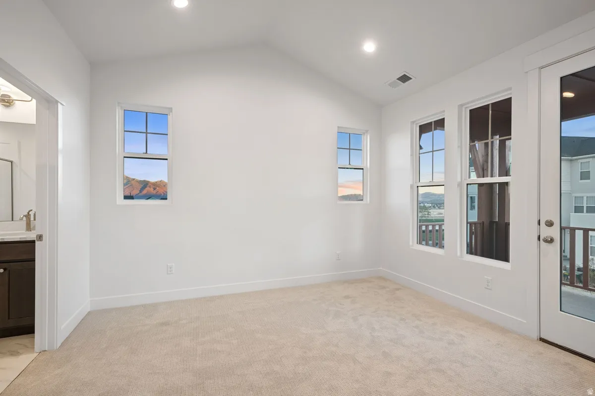 Spacious room with vaulted ceilings and recessed lighting