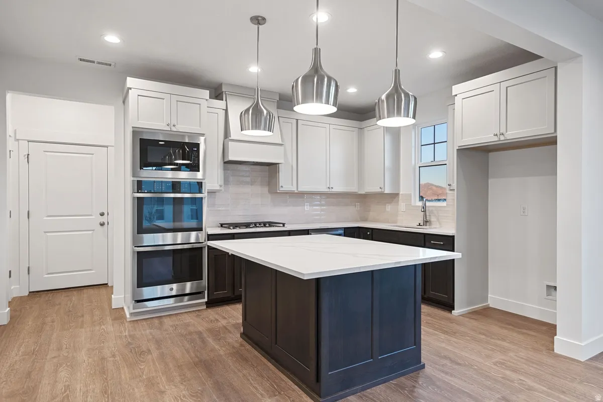 Modern kitchen featuring a large central island with a white countertop