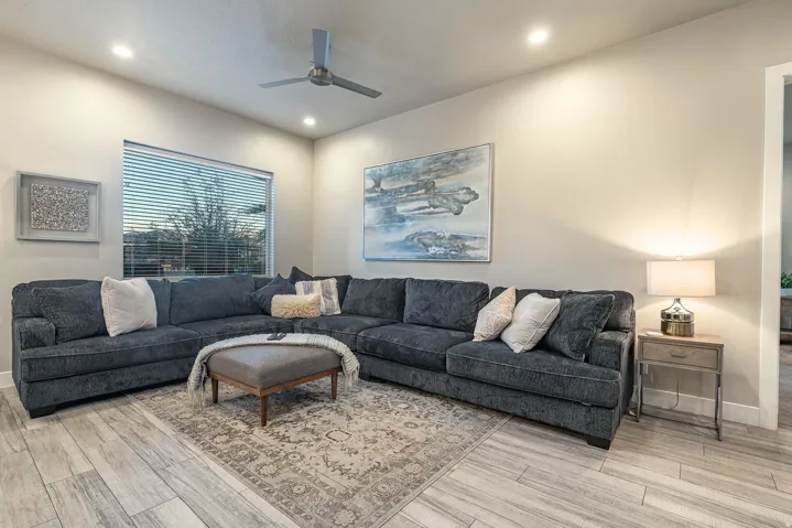 Living area featuring light wood-finish flooring, recessed lighting, and a ceiling fan