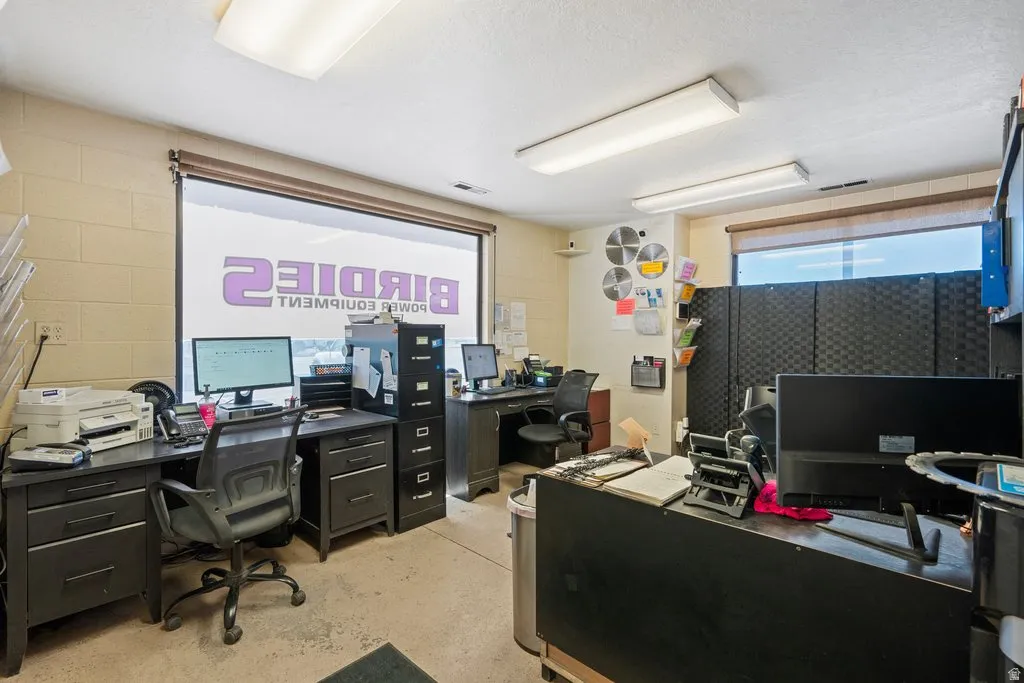 Interior office space featuring a large storefront window and recessed lighting