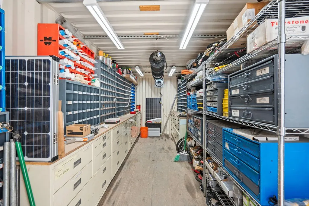 Dedicated workspace with extensive metal shelving and integrated drawer units