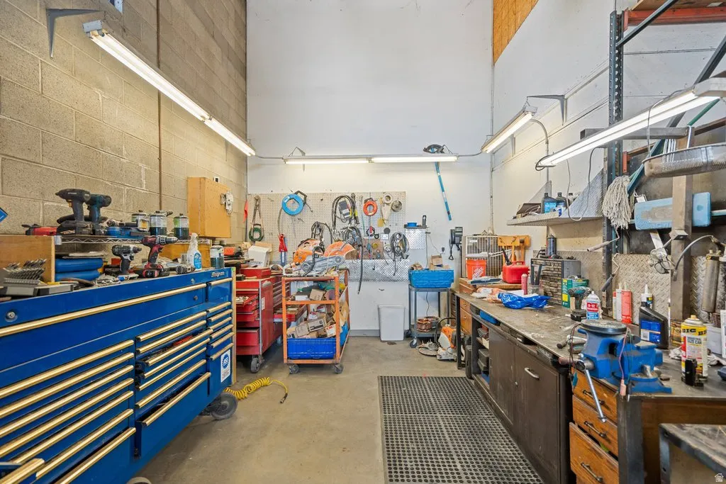High ceilings with exposed wood framing and block wall construction