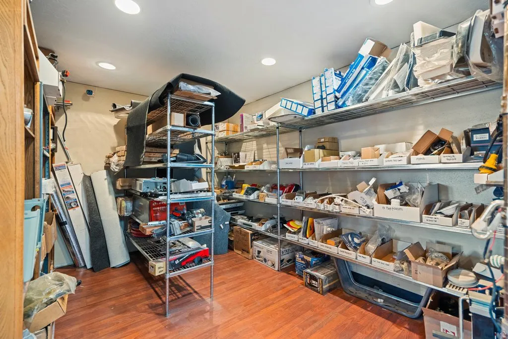 Interior space featuring wood-finish flooring, recessed lighting, and extensive built-in metal shelving