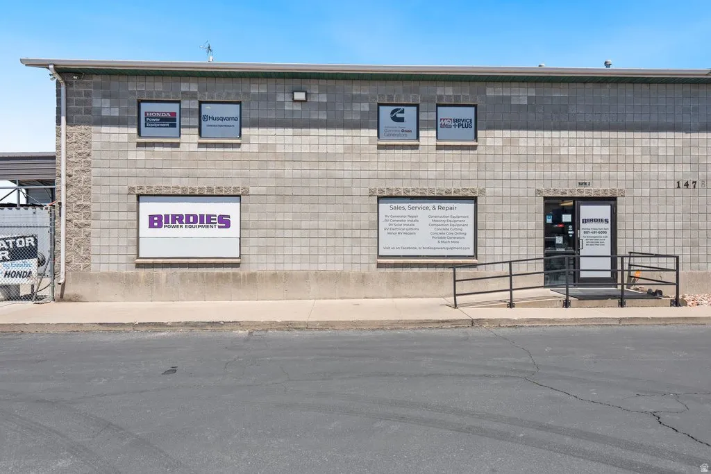 Commercial building with a block facade, an accessible entry ramp, and an integrated glass paneled door