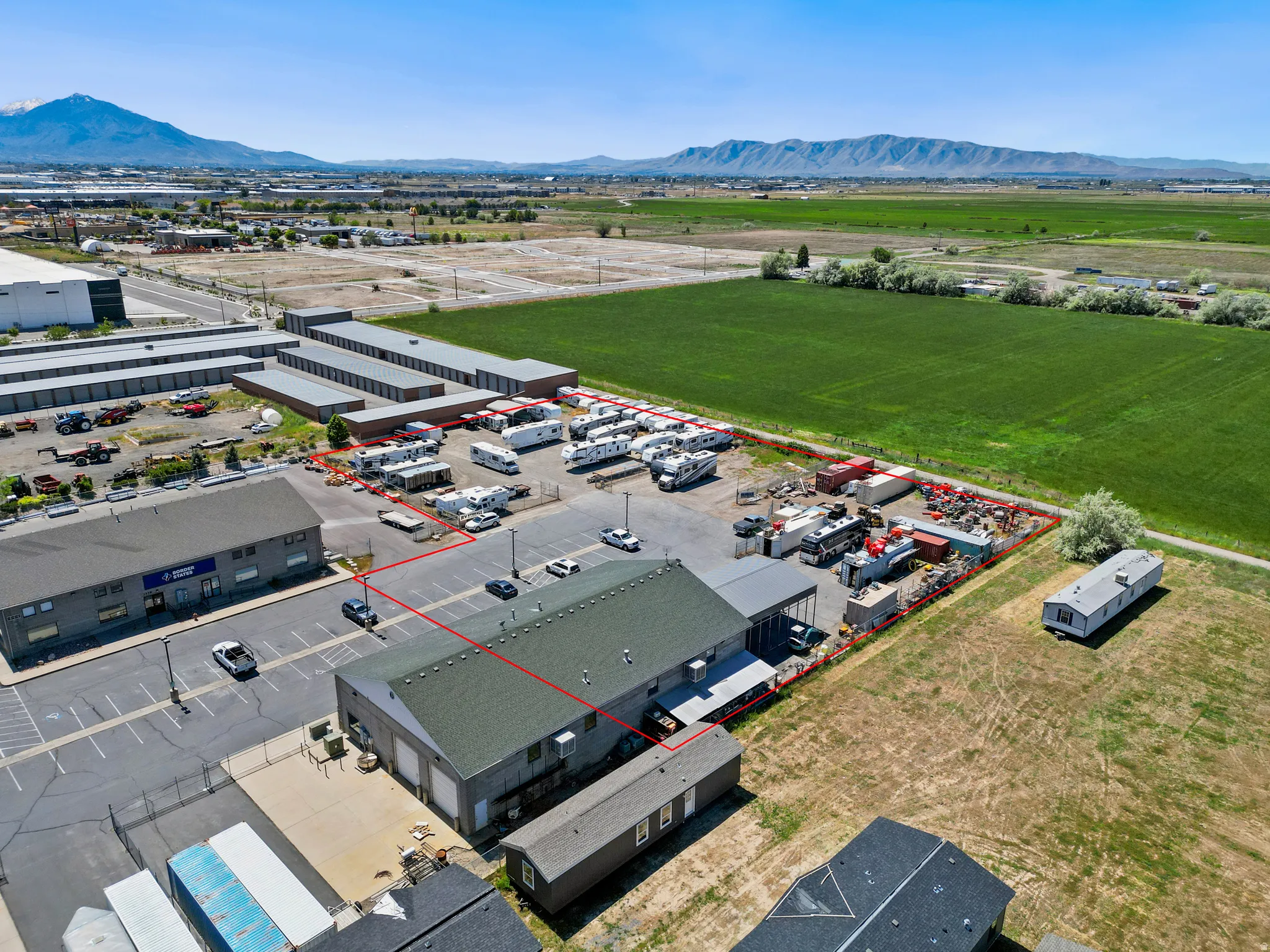 Expansive commercial property, paved parking areas, and open storage space