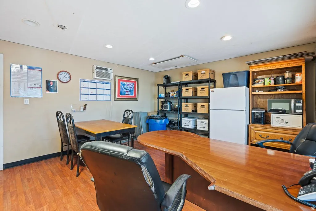 Versatile interior space featuring wood-finish flooring, recessed lighting, and an overhead air conditioning unit