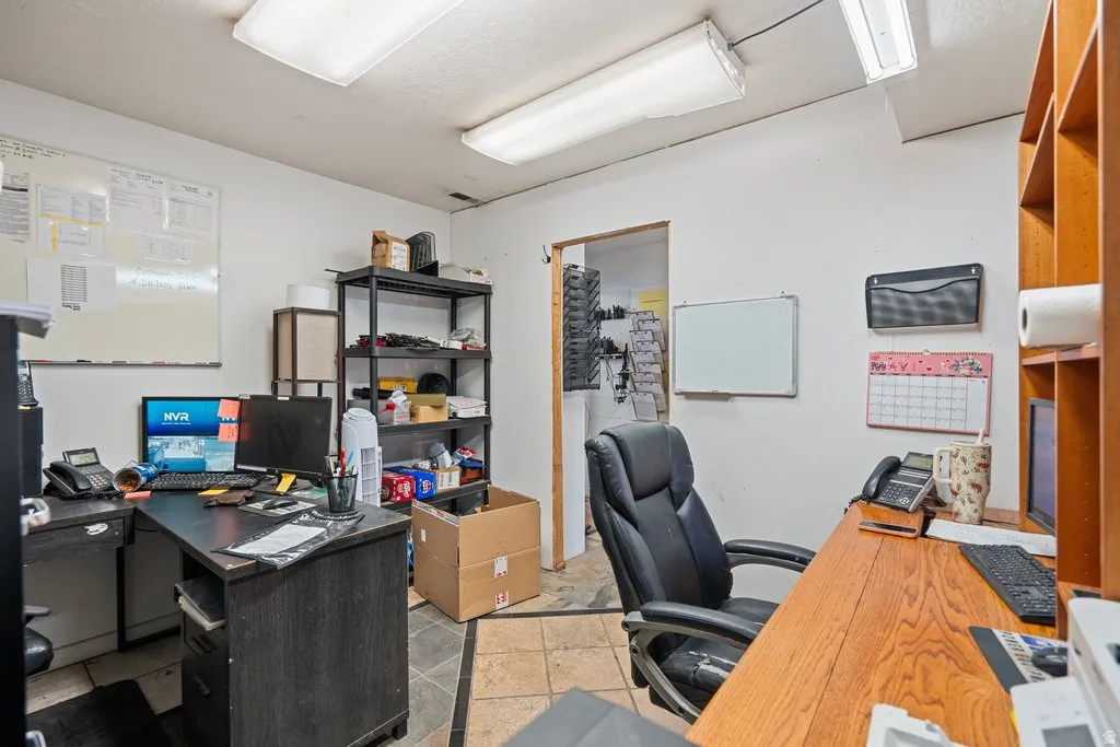 Office space featuring white walls and tile flooring