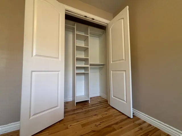 Wood-finish flooring with a white baseboard