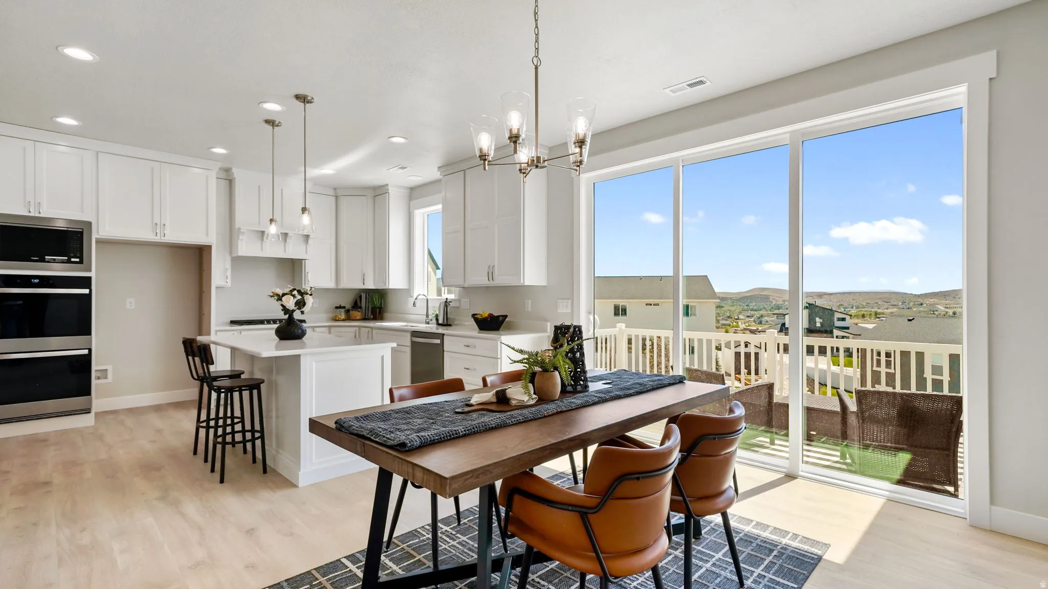Open-concept kitchen and dining area featuring light wood-finish flooring