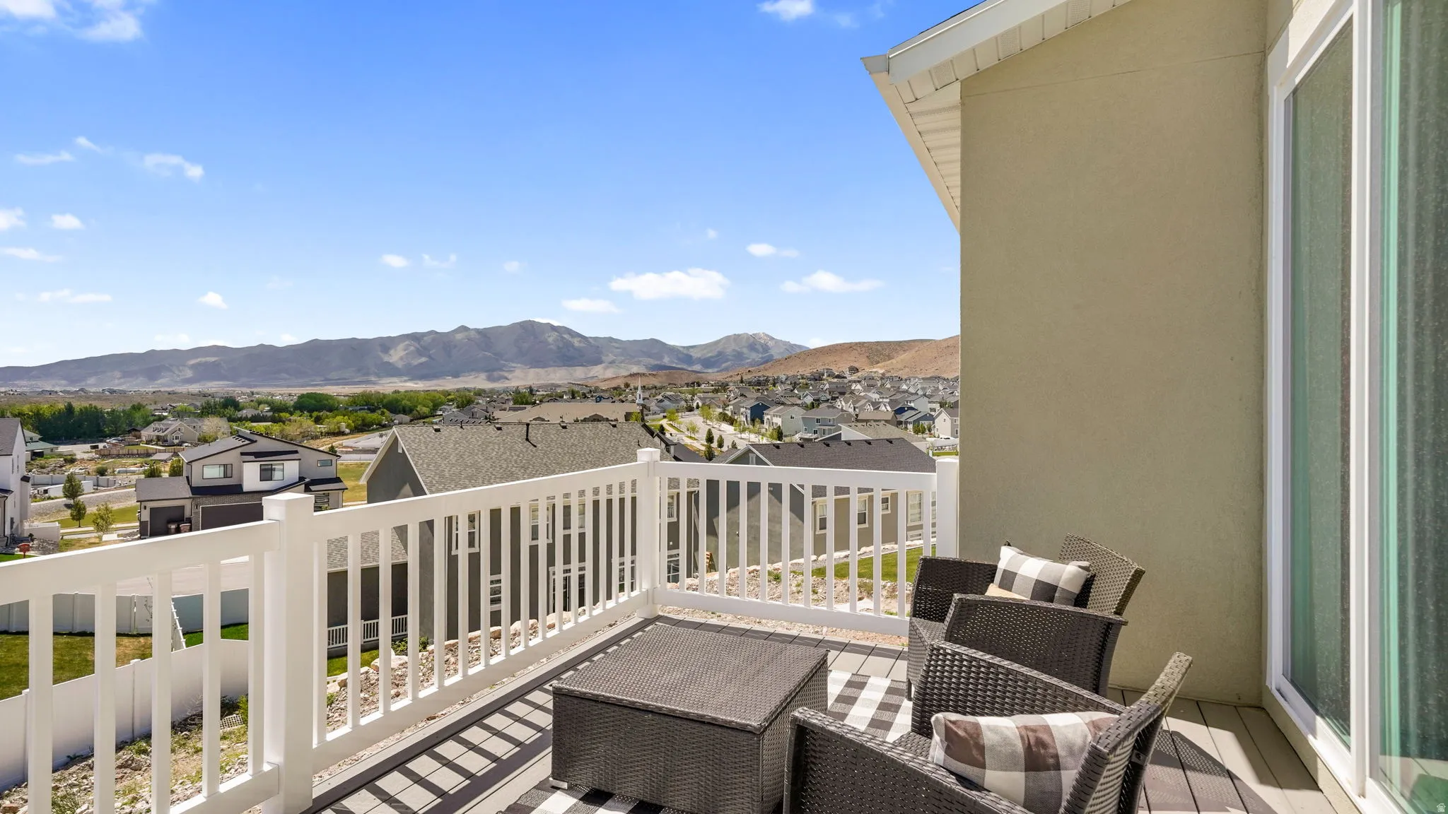 Elevated outdoor deck with a white railing and composite wood-finish flooring