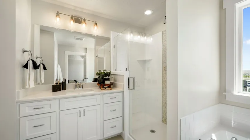 Spacious bathroom featuring a white vanity with an undermount sink and a large mirror
