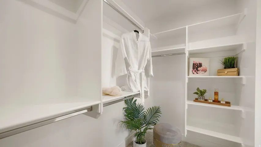 White built-in closet system featuring multiple shelves and hanging rods