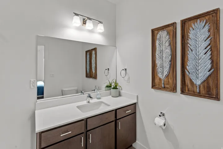 Bathroom vanity featuring a rectangular undermount sink, a chrome-finish faucet, and a light-toned countertop
