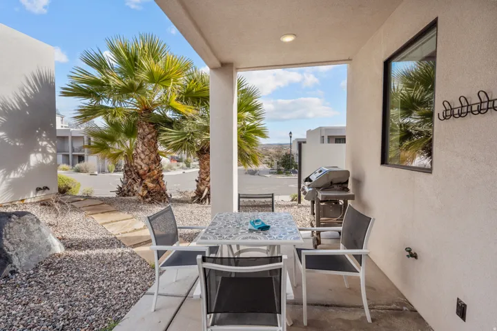 Covered patio featuring recessed lighting, a stucco exterior, and a permanent wall-mounted coat rack