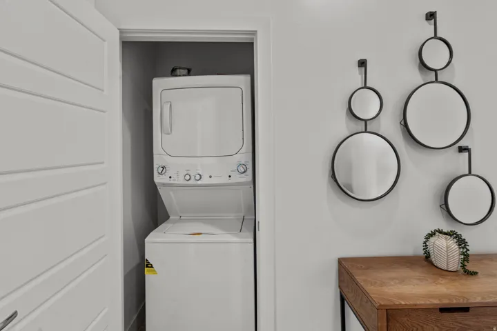 Dedicated laundry closet featuring a stacked washer and dryer