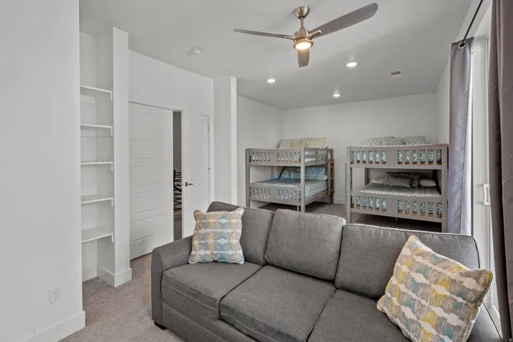 Recessed lighting illuminates this room featuring two built-in bunk bed structures