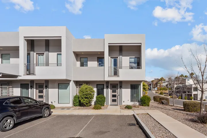 Contemporary exterior with light gray stucco and dark gray accents