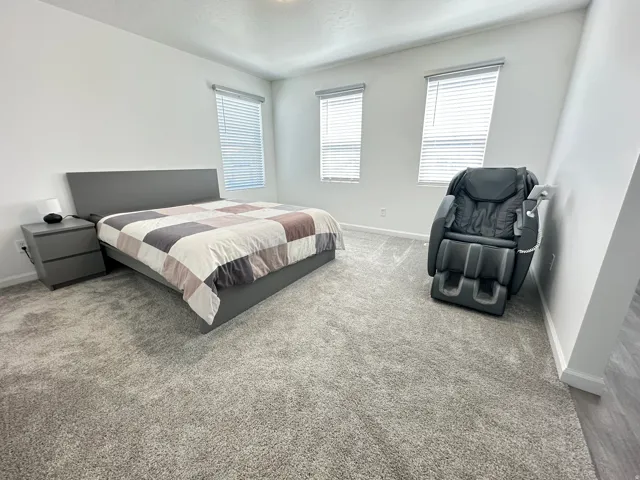 Spacious room featuring light gray carpet flooring and neutral wall tones