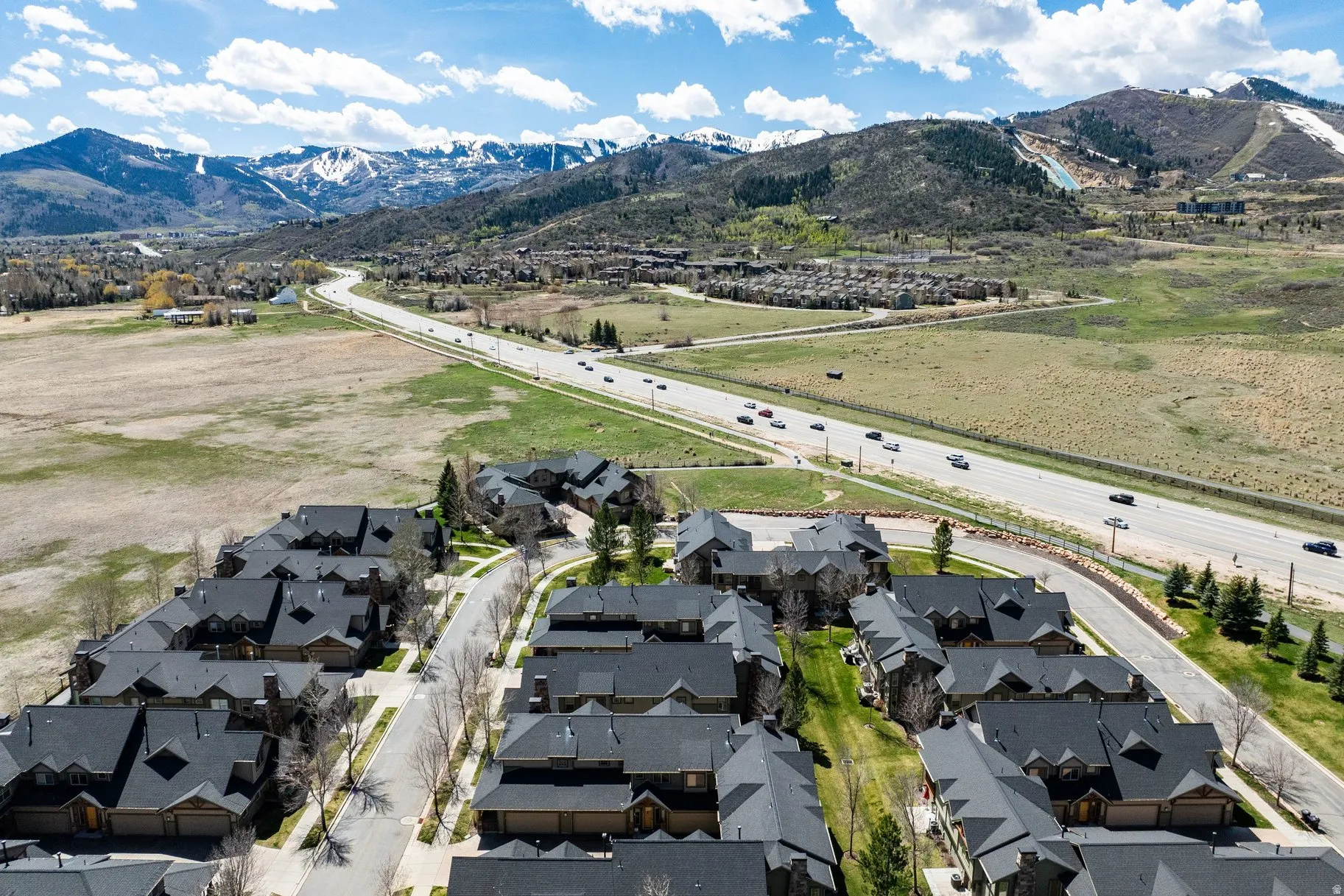Aerial perspective featuring a residential community with dark-toned roofs