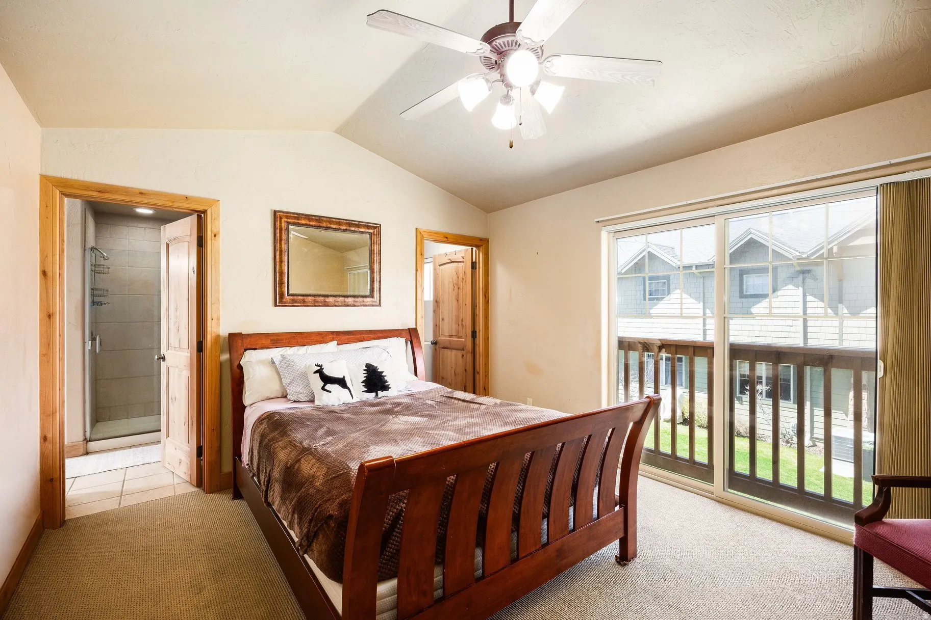 Carpeted room featuring a vaulted ceiling and a ceiling fan with integrated lighting