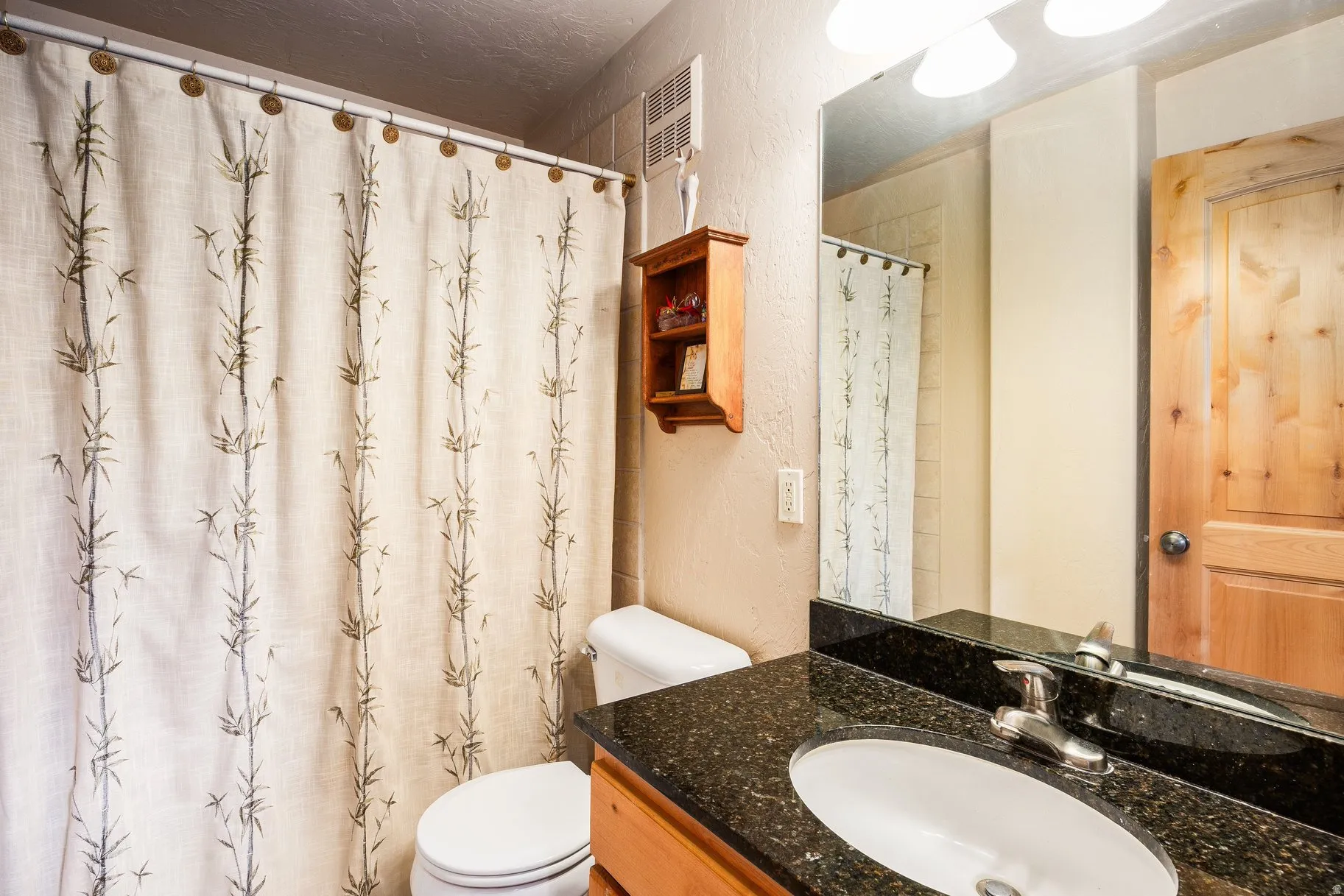 Granite countertop vanity with integrated sink and chrome faucet