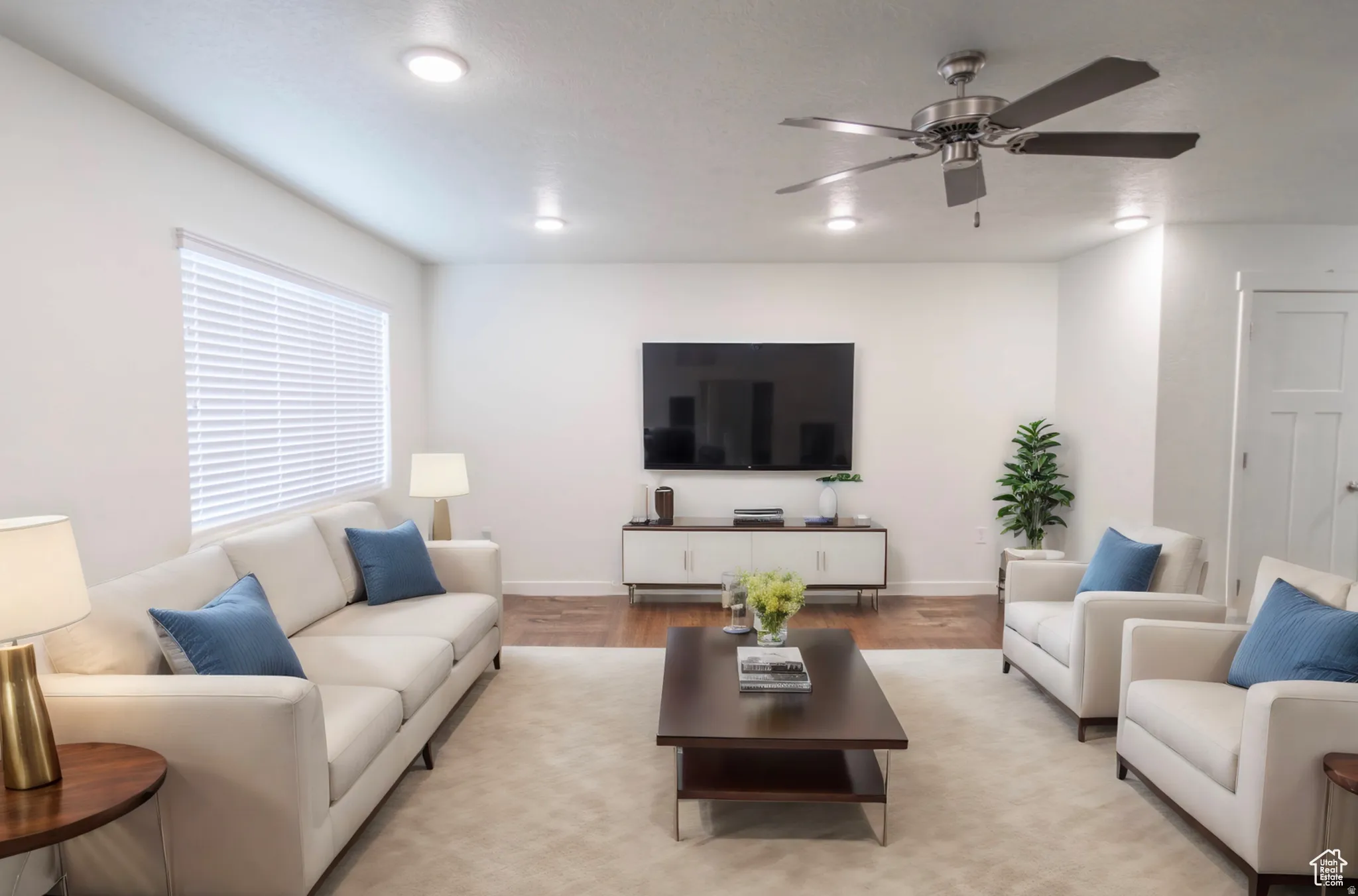 Expansive living area featuring recessed lighting and a ceiling fan