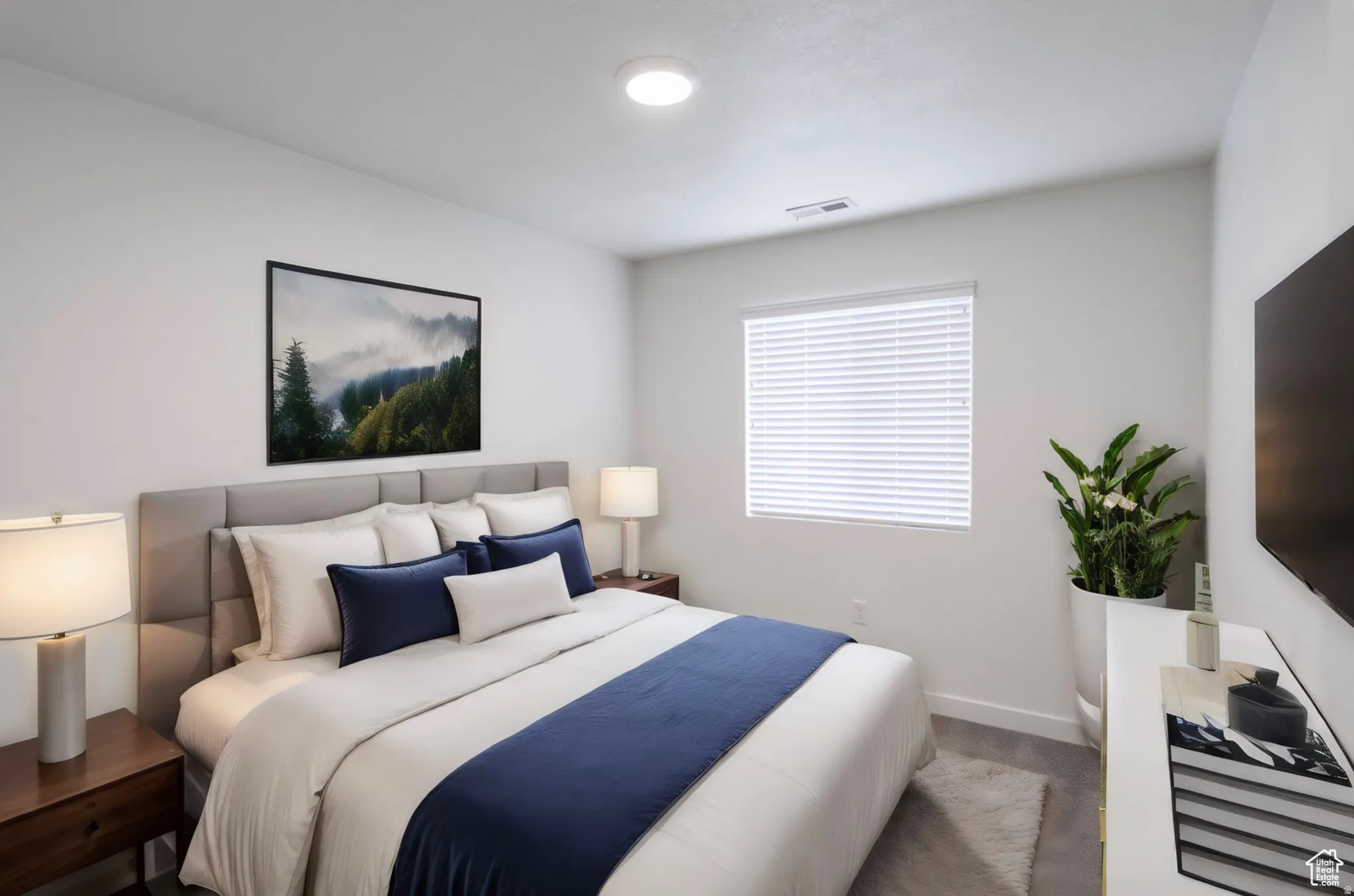 Bedroom featuring light gray carpeting and white walls