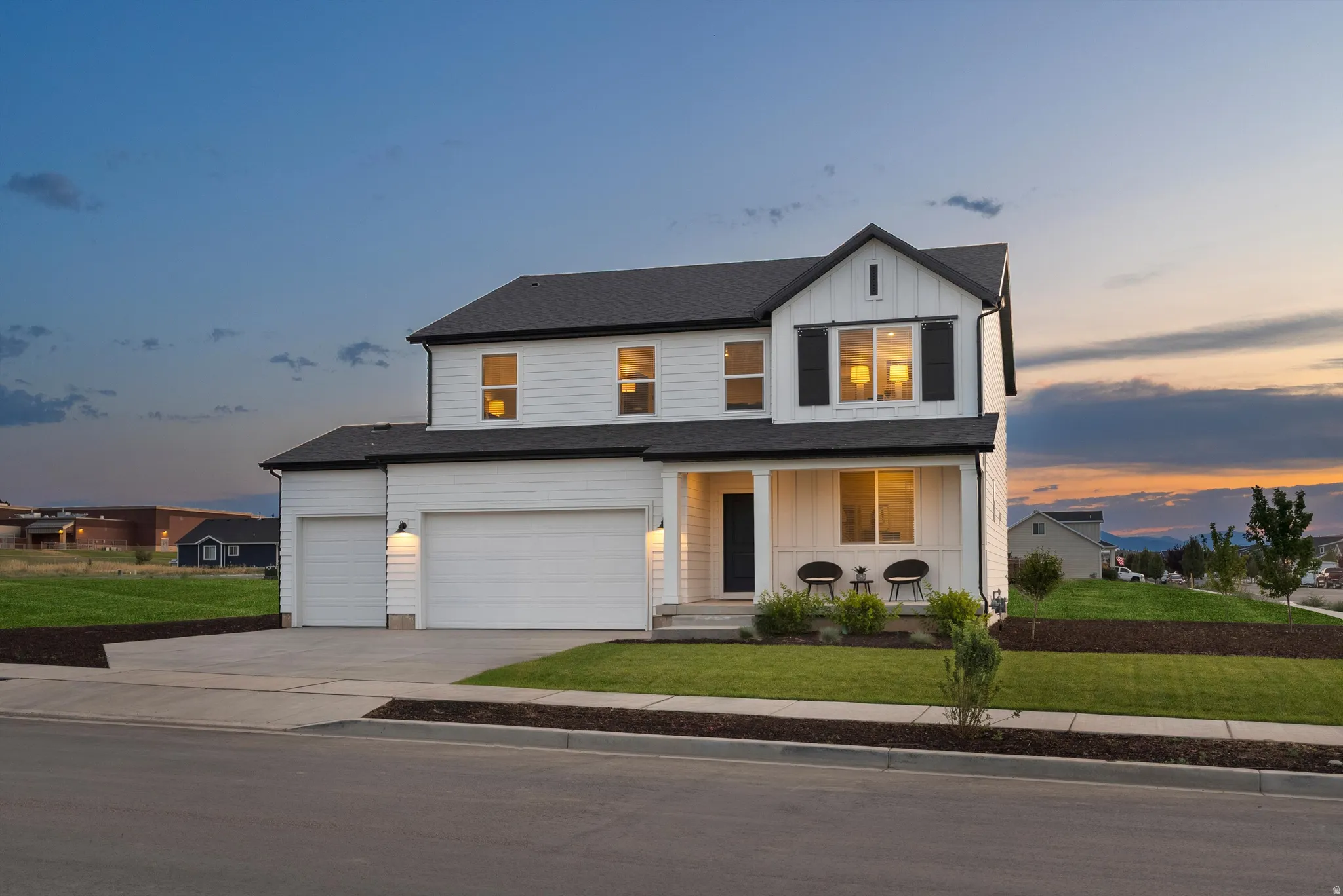 Modern farmhouse-style residence with white horizontal siding and black trim accents