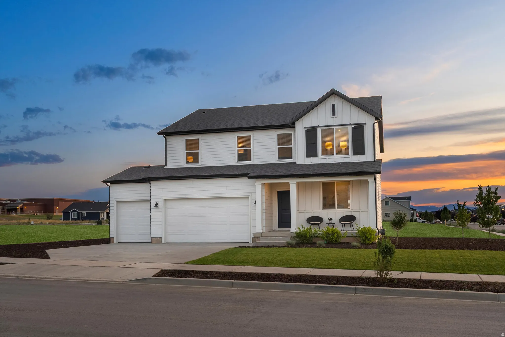 Modern farmhouse exterior with white siding and dark trim