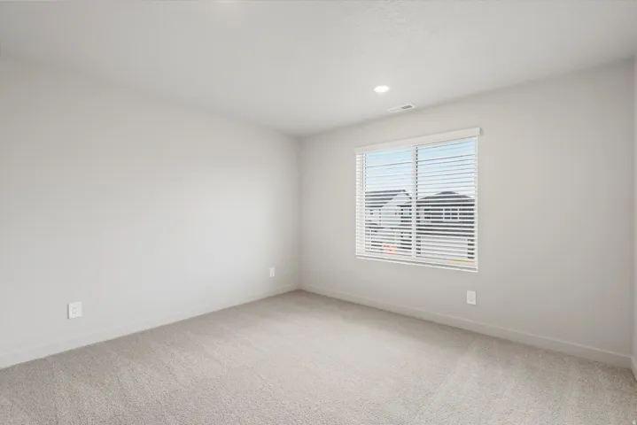 Neutral-toned wall paint and plush carpet flooring
