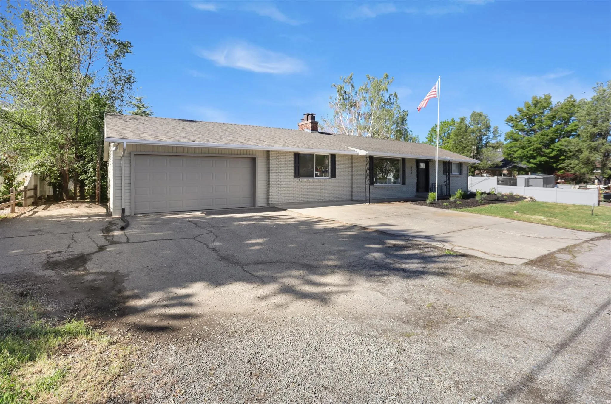 Single-story residence featuring a two-car garage and a paved driveway