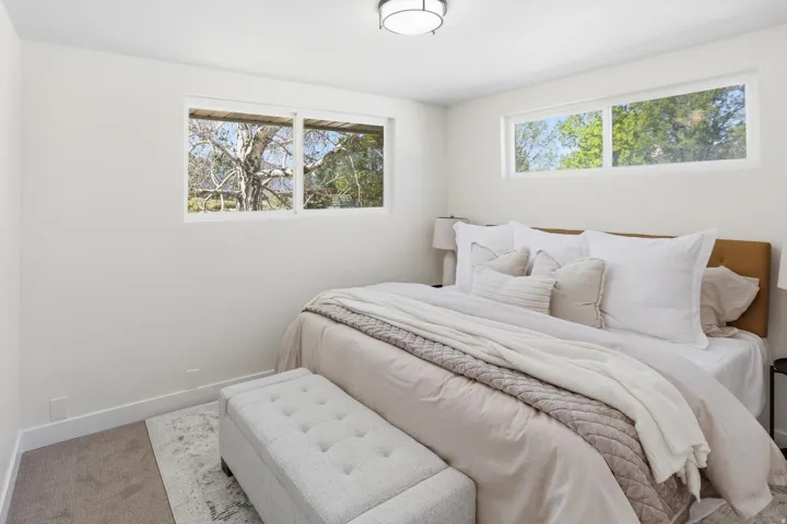 Bedroom with neutral wall color and light gray carpet